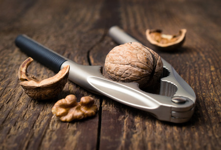 nutcracker and walnuts on a wooden backgroundの写真素材