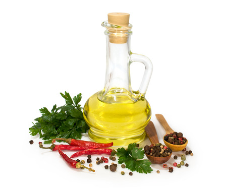 sunflower oil in a bottle with spices isolated on whiteの写真素材