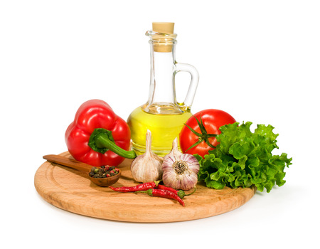 fresh vegetables , spices and olive oil in a bottle isolated on whiteの写真素材