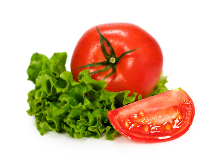 tomato with leaves of lettuce isolated on whiteの写真素材