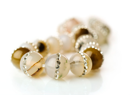 necklace made of agate inlaid rhinestones isolated on whiteの写真素材