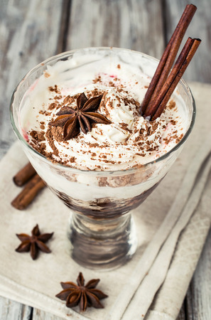 dessert with whipped cream , cocoa and cinnamon sticksの写真素材