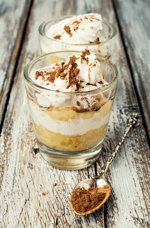 banana dessert with whipped cream on a wooden backgroundの写真素材