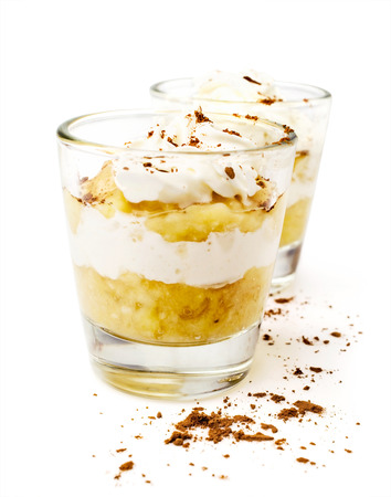 banana dessert with whipped cream isolated on whiteの写真素材