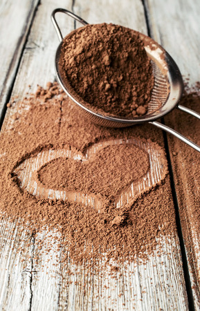 heart painted on cocoa powder and sieveの写真素材