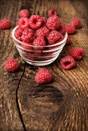 fresh raspberries on a wooden background closeup