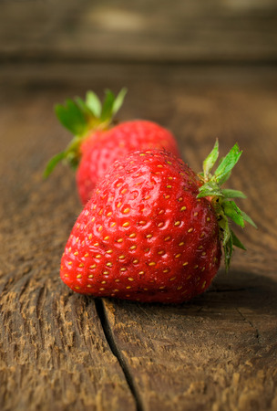 ripe strawberry close-up on wooden backgroundの写真素材