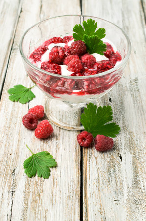 raspberry dessert with yogurt and fresh berries in a glass vase