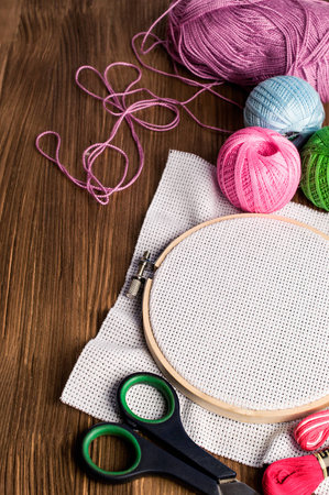 Set Embroidery : Threads and accessories and hoop on a wooden background