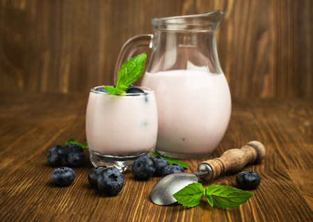 blueberry yogurt with fresh berries on woodenの写真素材
