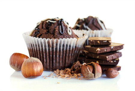 chocolate muffins with hazelnuts isolated on whiteの写真素材