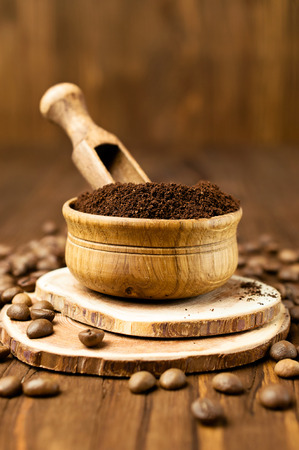 Ground coffee beans in a wooden bowl close-upの写真素材