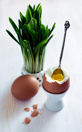 Boiled eggs and wild leek on tableの写真素材