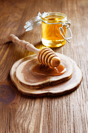 Wooden dipper with honey in rustic styleの写真素材