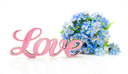 Forget-me-not flowers and word "love" isolated on whiteの写真素材