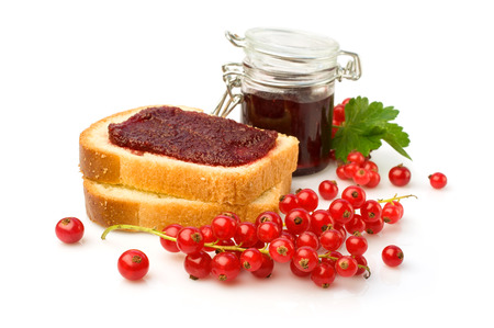 Red currant jam and fresh berries isolated over whiteの写真素材