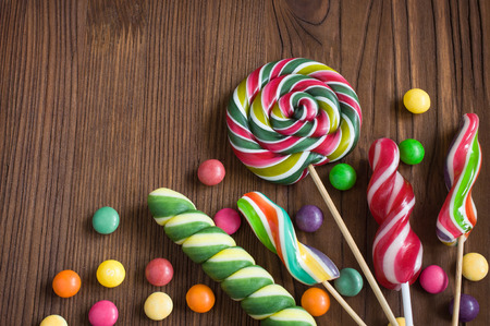 Colorful candies on a wooden backgroundの写真素材