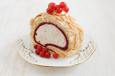Sweet dessert roll with berries on a saucerの写真素材