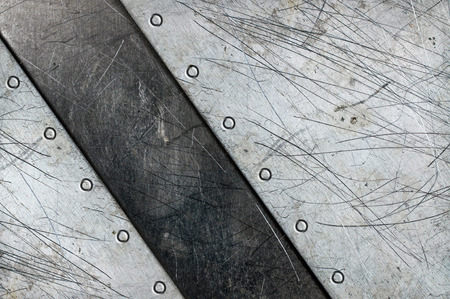 Grunge aluminum textured background with rivets and scratchesの写真素材