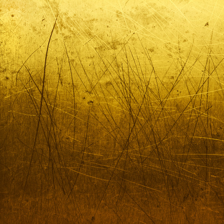 Grungy brushed golden metal plateの写真素材