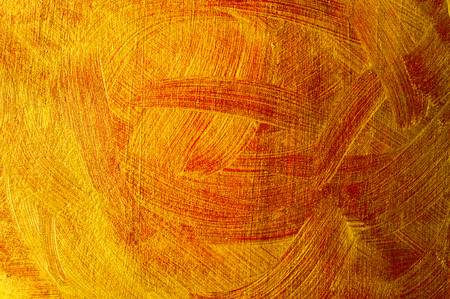 Abstract background with dabs of gold and red paintの写真素材