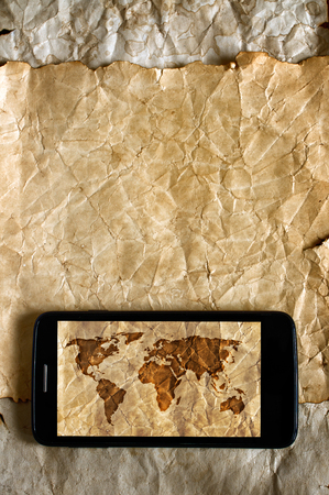 Old map and smartphone. Travel concept and backgroundの写真素材
