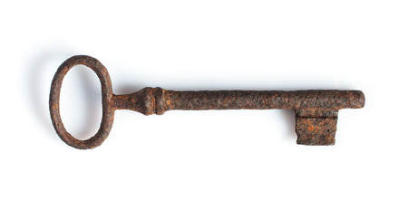 Ancient rusty key isolated on white