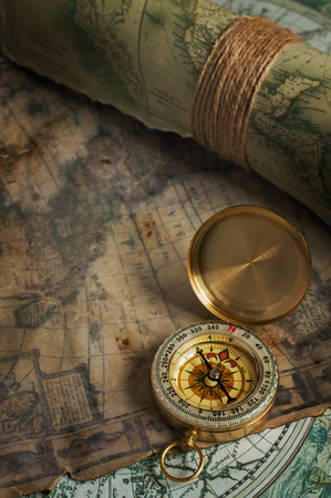 Nautical background. Vintage bronze compass and old maps.の写真素材