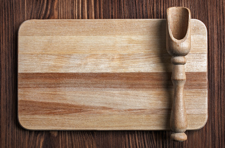 Wooden kitchen utensils on a wooden table, top view. Cutting board and shovels.の写真素材