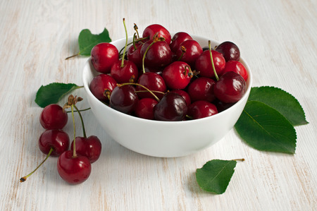 Ripe red cherries on a wooden table