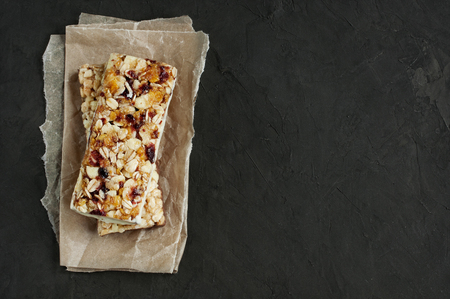Healthy cereal bars with nuts on a dark backgroundの写真素材