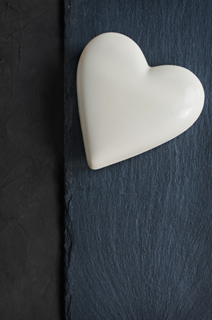 White chocolate heart on black slate backgroundの写真素材