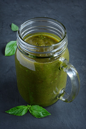 Healthy eating, green smoothie with basil on a black slate backgroundの写真素材