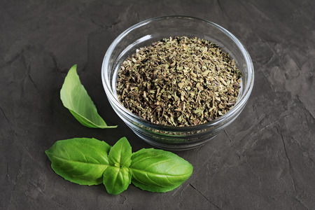 Dried and fresh basil on dark backgroundの写真素材