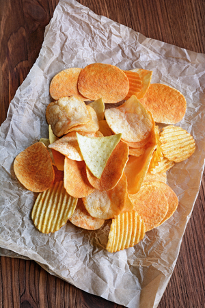 Crispy potato chips on wooden rustic tableの写真素材