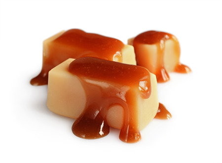 Delicious caramel candies isolated on white backgroundの写真素材
