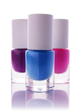 Blue, pink and violet nail polish isolated on whiteの写真素材