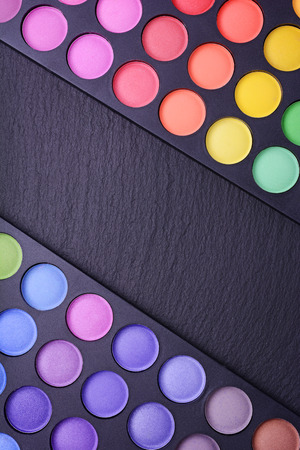 Professional multi colored eyeshadows palette on black slate backgroundの写真素材