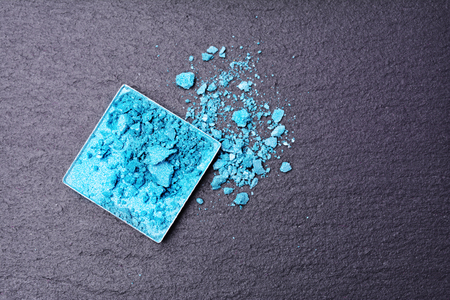 Turquoise crushed eyeshadows on black slate backgroundの写真素材