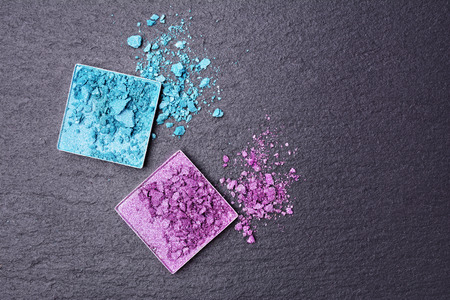 Turquoise and purple the crushed eyeshadows on black slate backgroundの写真素材