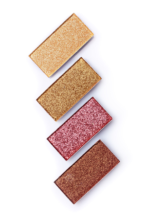 Brown and golden eyeshadows isolated on white backgroundの写真素材