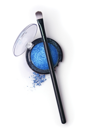 Blue pearlescent eyeshadow and brush for makeup isolated on whiteの写真素材