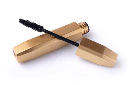 Black mascara in opened gold tube for make up isolated on whiteの写真素材