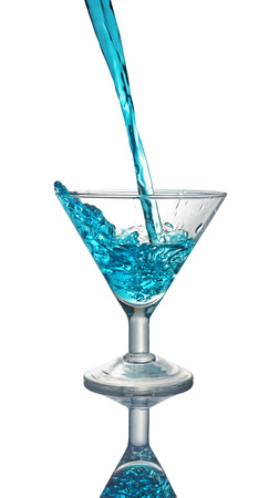Splash in glass of a blue alcoholic cocktail drink isolated on white backgroundの写真素材