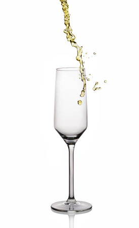 Splash of white wine in glass with reflection isolated on white backgroundの写真素材