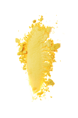 Smear of crushed yellow eyeshadow as sample of cosmetic product isolated on white backgroundの写真素材