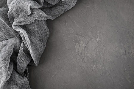 Table runner. Gray gauze fabric on dark concrete backgroundの写真素材