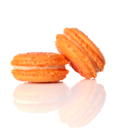 French dessert. Sweet yellow macaroons or macarons with orange flavor isolated on white backgroundの写真素材