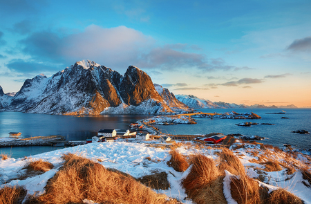 Beautiful sunrise landscape of picturesque fishing village in the mountains of Lofoten islands in Norwegian Sea, Norwayの写真素材