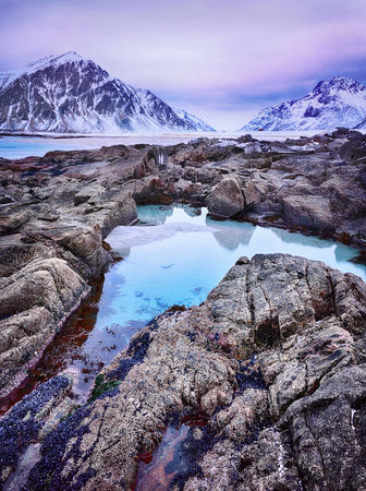 Beautiful sunset Norway landscape of picturesque stones on the arctic beach of Lofoten islands in cold Norwegian Sea, Norwayの写真素材